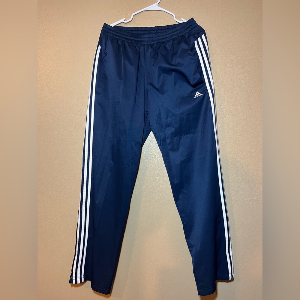 Navy blue adidas sweatpants with white strips